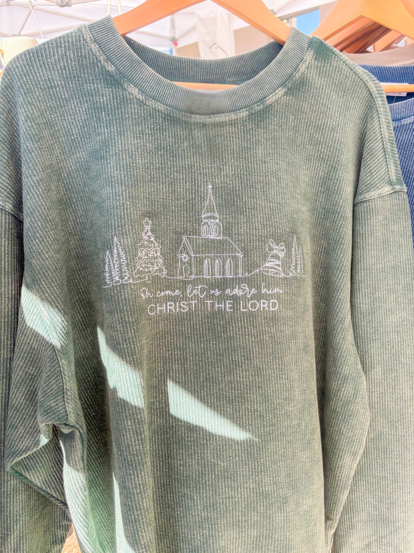 O come let us adore corded crewneck